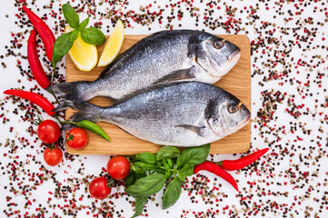 Raw dorado fish on wooden cutting board. Top view, copy space