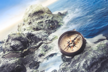 vintage compass on the sea shore