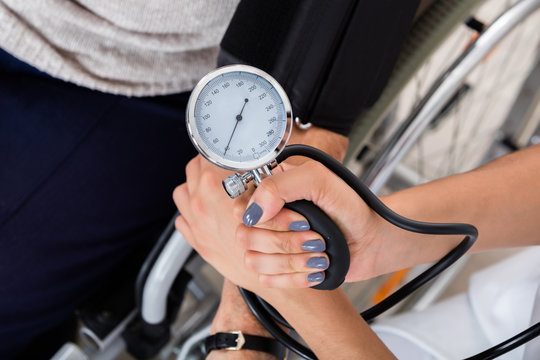 Doctor Checking Blood Pressure Of Patient