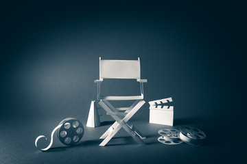 image with vintage texture of a Director chair and movie items
