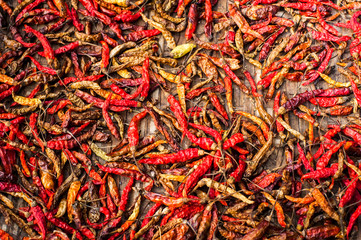 Fototapeta premium Dry red hot chili peppers at asian market. Organic food background