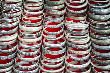 Lot of cheap souvenir bangles at asian market place. Laos