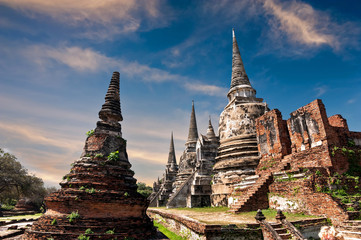 Asian religious architecture. Ancient Buddhist pagoda ruins at Wat Phra Sri Sanphet temple under sunset sky. Ayutthaya, Thailand travel landscape and destinations - obrazy, fototapety, plakaty