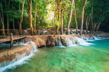 Jangle landscape with amazing turquoise water of Kuang Si cascade waterfall at deep tropical rain forest. Luang Prabang, Laos travel landscape and destinations