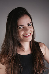 Naklejka premium Portrait of beauty brunette girl over gray background