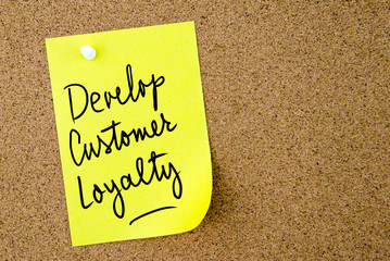 Develop Customer Loyalty text written on yellow paper note
