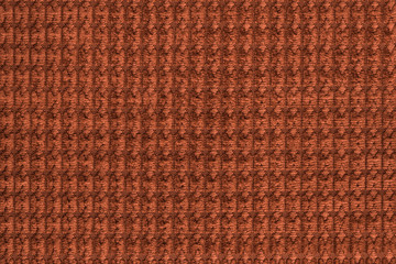 Dark orange background from soft fleecy fabric close up. Texture of textiles macro