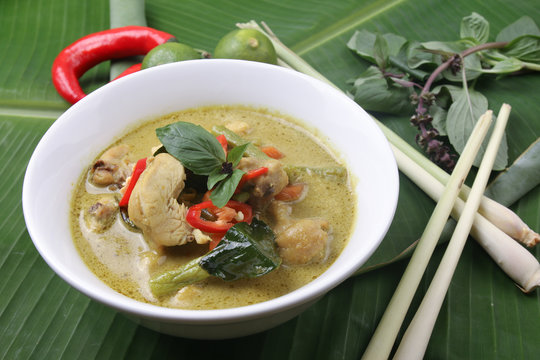 Thai green curry chicken on banana leaf surface
