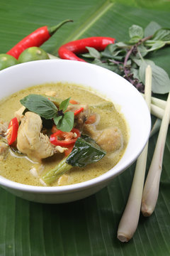 Thai green curry chicken on banana leaf surface