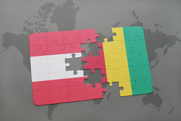 puzzle with the national flag of austria and guinea on a world map background.