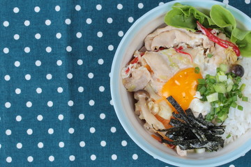 Jasmine rice is topped soft boil eggs and fried pork in Japanese style  as 