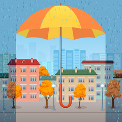 огромный желто-оранжевый зонтик защищает осенний город от дождя - obrazy, fototapety, plakaty
