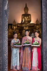 Women in Thai dress at the old temple. Noppamas Queen Contest in Loy kratong tradition.

