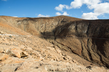 Beautiful volcanic mountains and the road on a mountain slope.  Road from la Pared to Betancuria ....