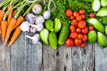 Assortment of vegetables, overhead on rustic wooden table