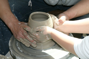 potter teaches the student the art of clay pottery