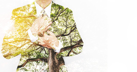 Double Exposure Businessman in Suit with Big Tree with Bright Sunlight and copy space