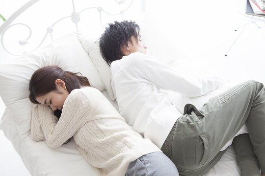 The couple are sleeping towards the back