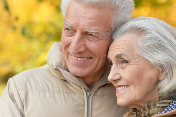 Portrait of a beautiful middle-aged couple in the autumn park
