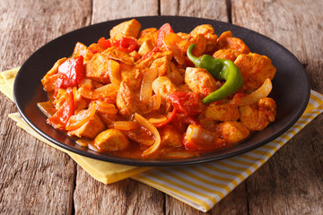 Indian Cuisine: Spicy chicken jalfrezi with pepper and onion close-up. horizontal   © FomaA