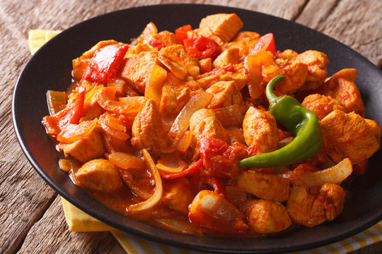 Spicy chicken jalfrezi with pepper and onion close-up. horizontal
