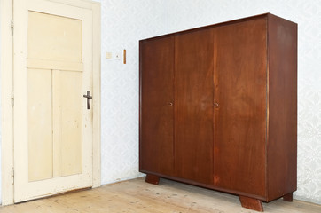 Old furniture  /  Old furniture in the empty room with doors. Doors are ivory colored.