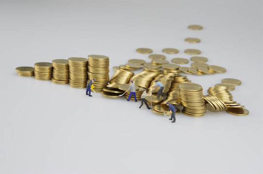 Piles of coins and miniature people