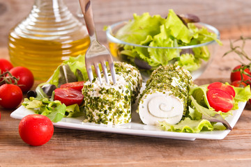 Goat cheese with salad and cherry tomatoes. 