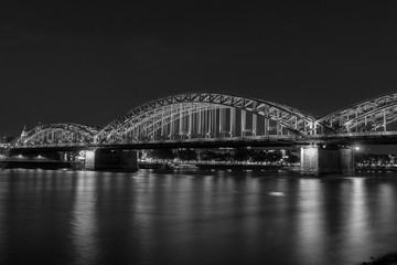 Illuminated bridge in Cologne at night in black and white