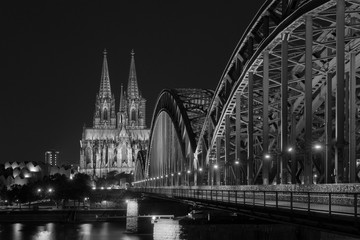 Illuminated bridge in Cologne at night in black and white