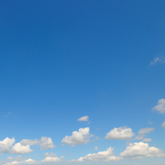light cumulus clouds in the blue sky