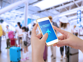 Hand holding smartphone with E-Ticket application for ticket reservation