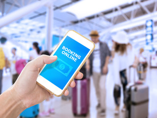 Hand holding smartphone with Online booking application for ticket reservation