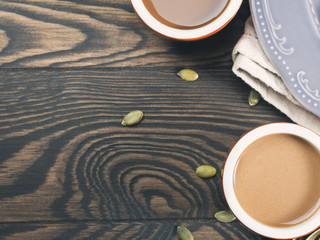 Wooden background with cups of coffee