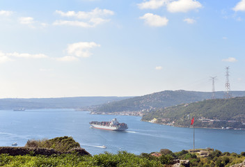 Fototapeta na wymiar A container ship at Bosphorus is moving to Marmara Sea