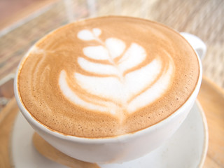 beautiful foam in coffee cup on table with sun light,selective f