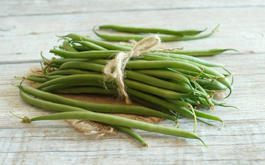 Green french beans on wood
