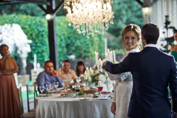 Happy wedding couple start their firs dance