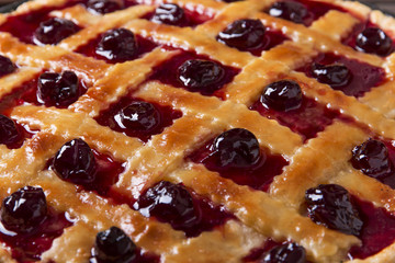 Homemade traditional sweet cherry  tart pie with  wooden table background.
