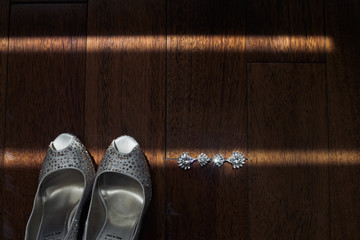 Fototapeta na wymiar The shoes and earrings for bride