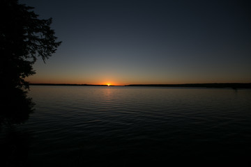 Naklejka na ściany i meble Sunset on a calm lake in Ontario Canada