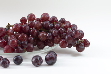  grape in dish glass on white table