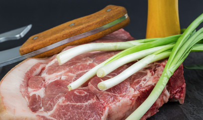 Piece of pork meat on a black stone table