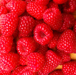 Raspberry berries on a wooden surface background