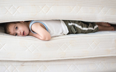 Lovely child laying down on the bed