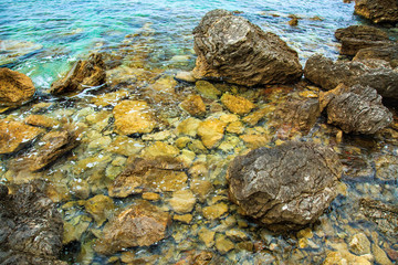 Beautiful seascape. Sea surface, rocks on the beach. Closeup cliff and stone on the shore.