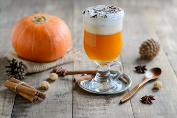 Healthy pumpkin smoothie in glasses on rustic background