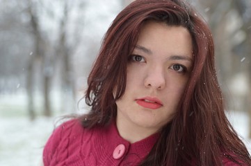 Beautiful woman outside while snowing