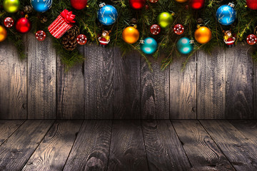 2017 Happy New Year seasonal background with real wood green pine, colorful Christmas baubles, gift boxe and other seasonal stuff over an old wooden aged background