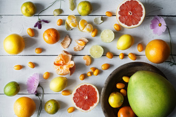 Citrus mix on the white wooden background  top view